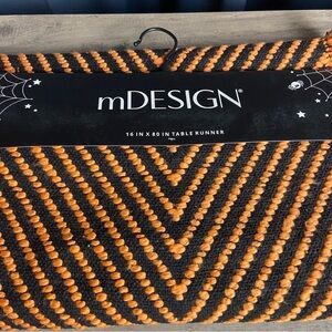 mDESIGN 16 x 80” table runner with an arbor stitch woven pattern, Orange & Black